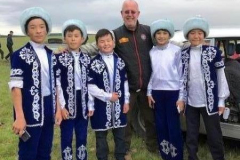 Paul-with-lovely-children-in-traditional-costume-in-Baldashino-Kazhakstan